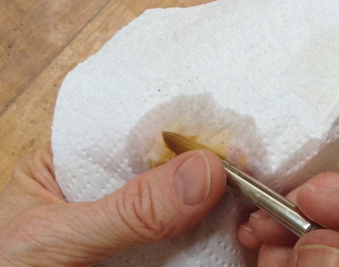 Wiping the brush after you load it